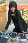 Fabeba displays her Nding Nding African print fabric jewelry in her stall.